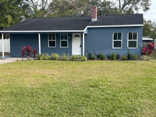 ranch-style home with a front lawn