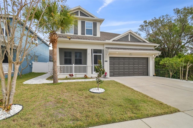 view of front of property featuring a garage and a front lawn