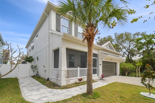 view of front facade with a front yard, a garage, and a porch