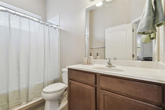 full bathroom with toilet, hardwood / wood-style flooring, shower / tub combo with curtain, and vanity