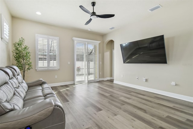 unfurnished living room with ceiling fan and hardwood / wood-style flooring