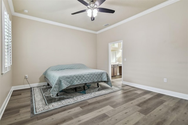 bedroom with ensuite bathroom, ceiling fan, hardwood / wood-style flooring, and crown molding