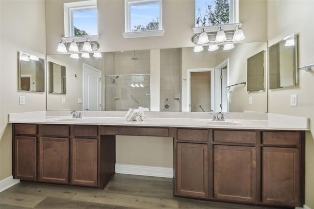 bathroom featuring an enclosed shower, vanity, hardwood / wood-style floors, and a wealth of natural light