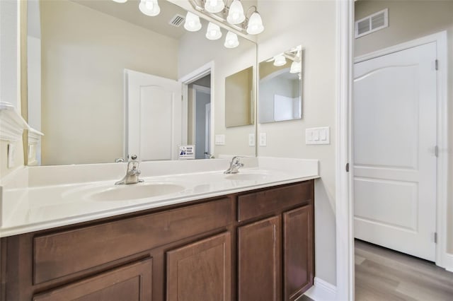 bathroom with vanity and hardwood / wood-style floors