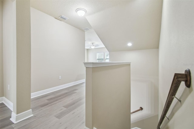 interior space featuring a textured ceiling and light hardwood / wood-style flooring