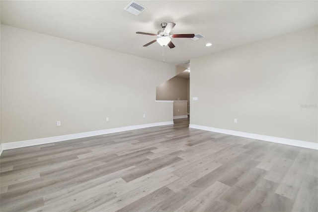 spare room featuring ceiling fan and light hardwood / wood-style flooring