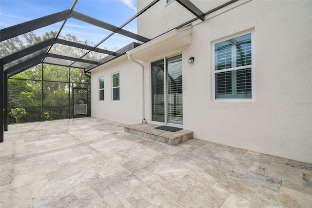 view of patio with glass enclosure