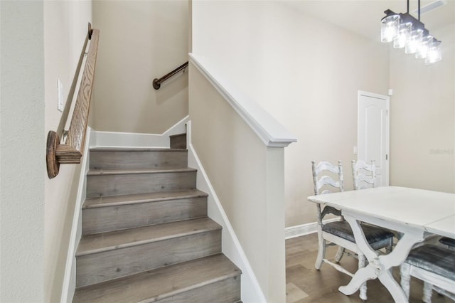 stairs with baseboards and wood finished floors