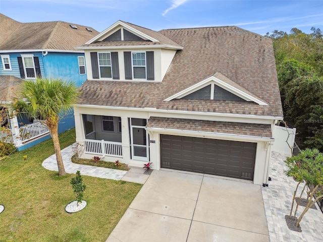 view of front of home with a front yard, roof with shingles, stucco siding, concrete driveway, and a garage