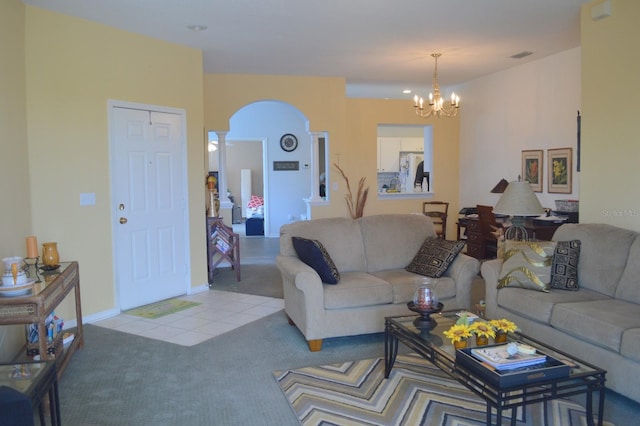 carpeted living room featuring a chandelier