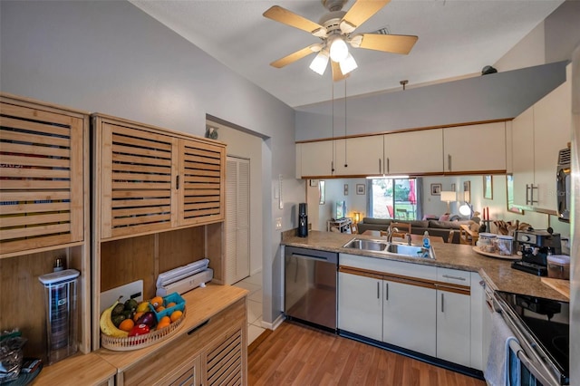 kitchen with sink, white cabinetry, light wood-type flooring, ceiling fan, and appliances with stainless steel finishes