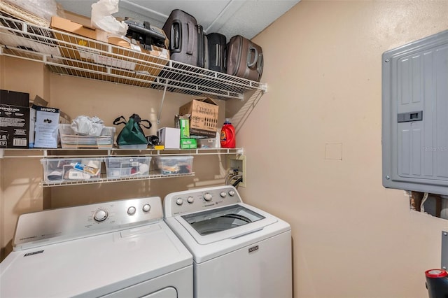 washroom featuring electric panel and washer and clothes dryer