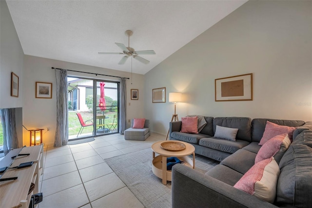 living room with light tile patterned floors, ceiling fan, and vaulted ceiling