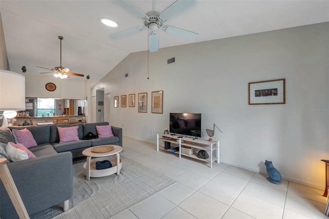 tiled living room with ceiling fan and high vaulted ceiling