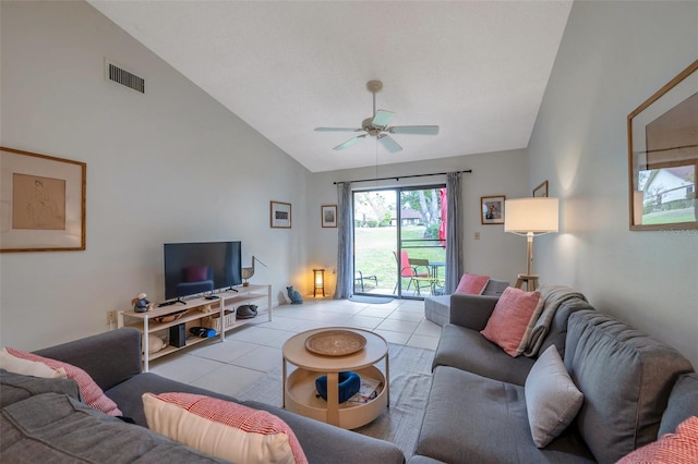 living room with vaulted ceiling, ceiling fan, and light tile patterned floors