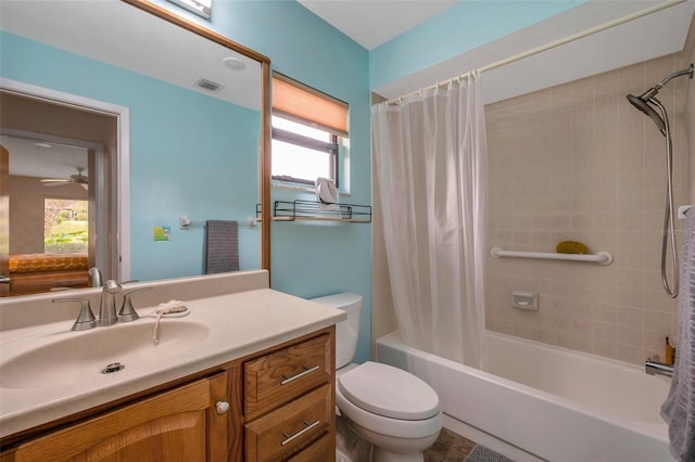 full bathroom featuring toilet, shower / bathtub combination with curtain, ceiling fan, and vanity