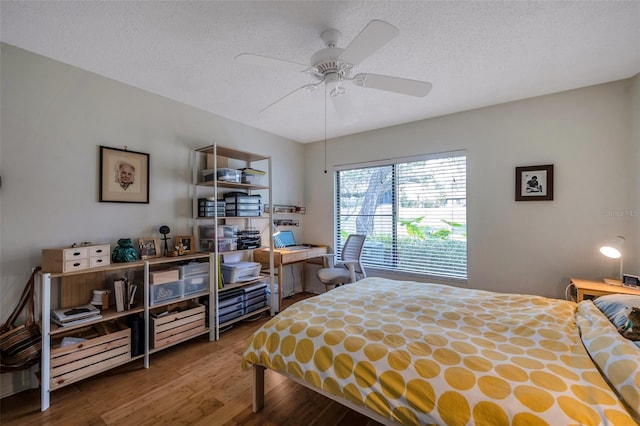 bedroom featuring ceiling fan, a textured ceiling, and hardwood / wood-style flooring