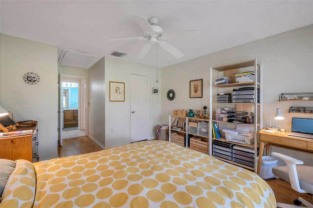 bedroom featuring ensuite bath, light wood-type flooring, and ceiling fan