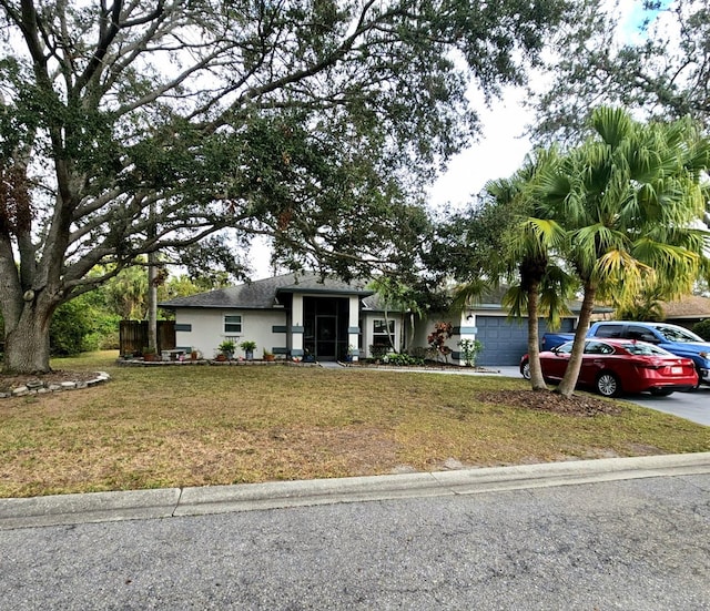 view of front of house featuring a front yard and a garage