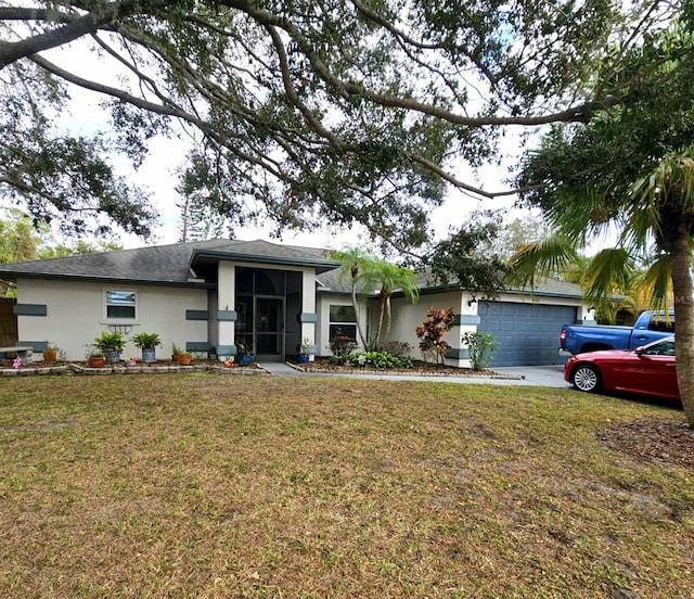 view of front of property featuring a garage and a front yard