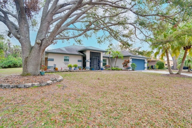 ranch-style home featuring stucco siding, concrete driveway, a front lawn, and a garage