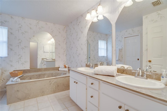 full bath featuring a sink, visible vents, a textured ceiling, and wallpapered walls