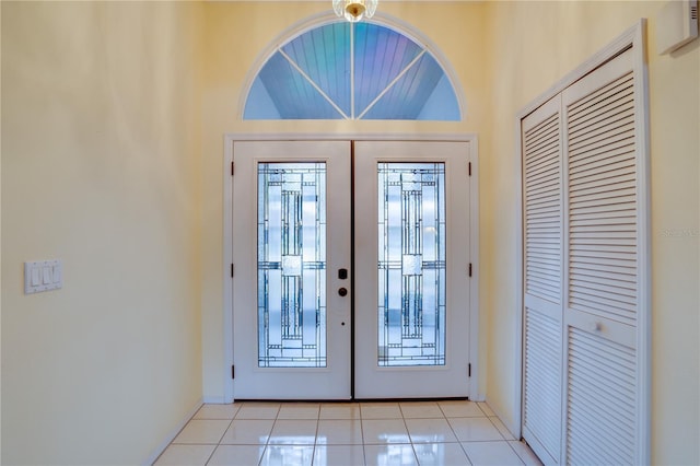 doorway to outside with light tile patterned floors and french doors