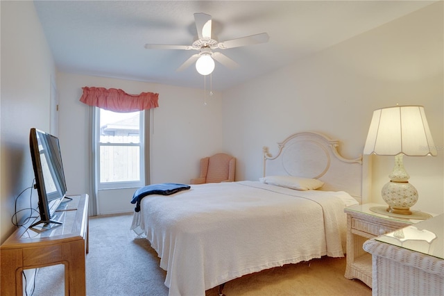 bedroom with light carpet and a ceiling fan