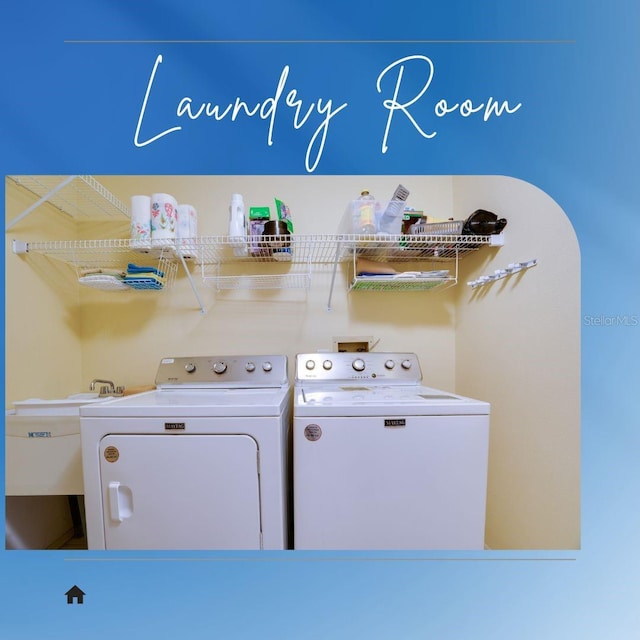 laundry area featuring laundry area, independent washer and dryer, and a sink