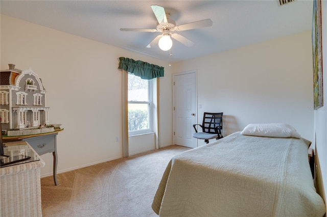 bedroom with baseboards, carpet floors, visible vents, and a ceiling fan