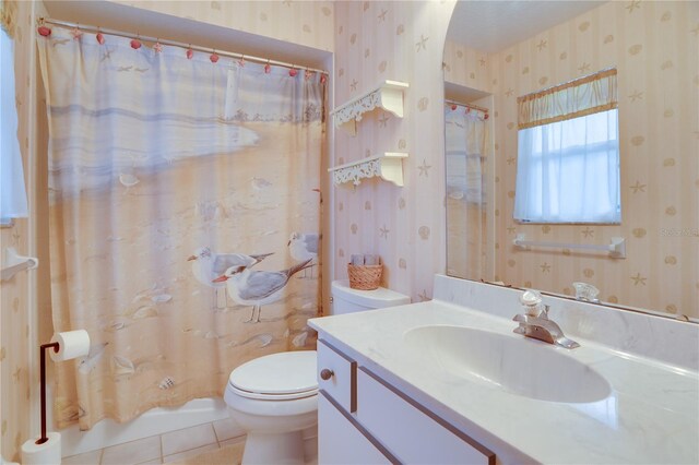 bathroom with wallpapered walls, tile patterned floors, and toilet