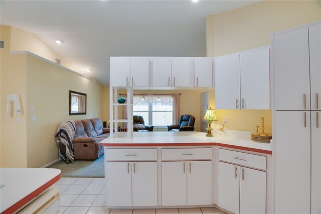 kitchen featuring light tile patterned floors, white cabinetry, open floor plan, and light countertops