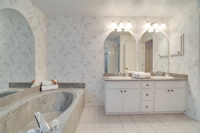 4553 31st Ct E, Bradenton, FL 34203 - bathroom with double vanity, a garden tub, tile patterned flooring, a textured ceiling, and an enclosed shower