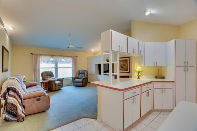 4553 31st Ct E, Bradenton, FL 34203 - kitchen with open floor plan, light colored carpet, light countertops, a peninsula, and light tile patterned floors