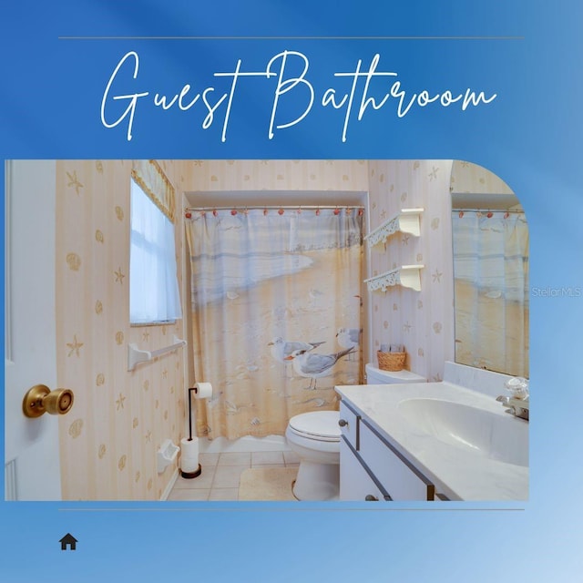 4553 31st Ct E, Bradenton, FL 34203 - bathroom featuring wallpapered walls, toilet, tile patterned floors, vanity, and a shower with curtain