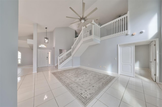 interior space featuring high vaulted ceiling, ceiling fan, and light tile patterned floors