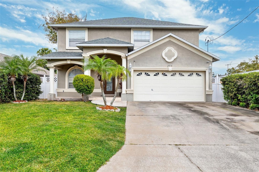 view of front of property with a front yard and a garage