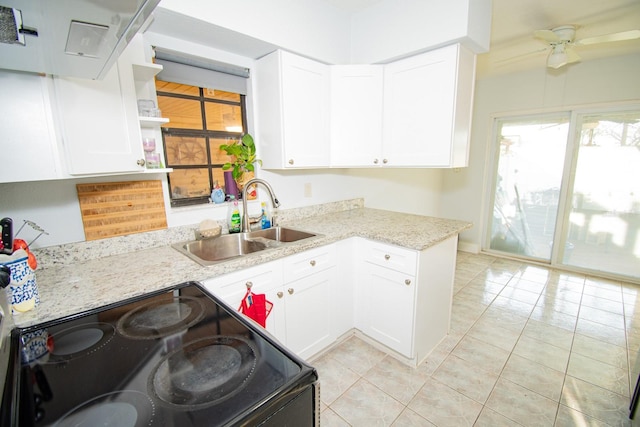 kitchen with white cabinets, ceiling fan, light stone counters, sink, and black / electric stove