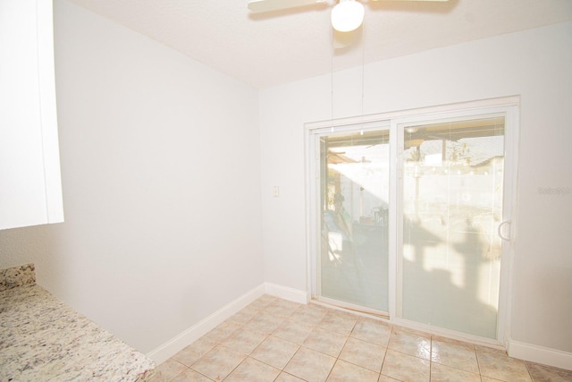 interior space with ceiling fan and light tile patterned floors