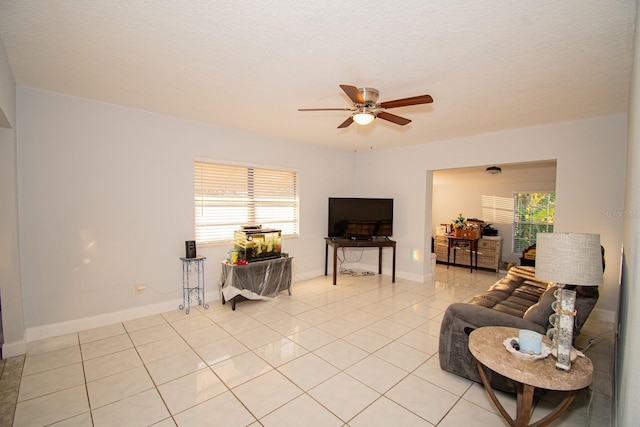 living room featuring ceiling fan and light tile patterned floors