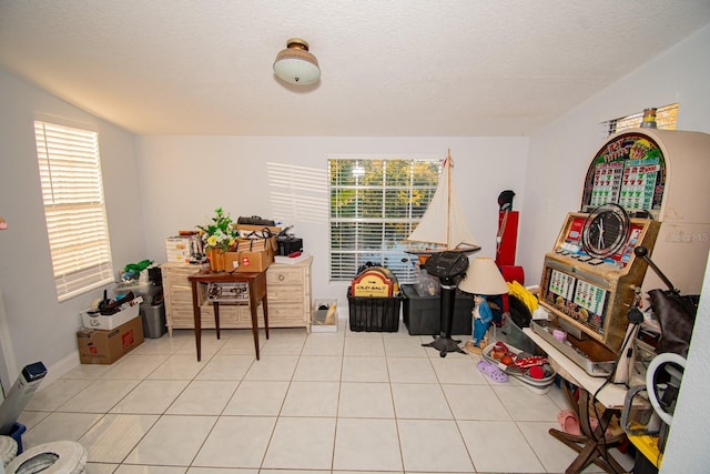 interior space with light tile patterned flooring and a textured ceiling