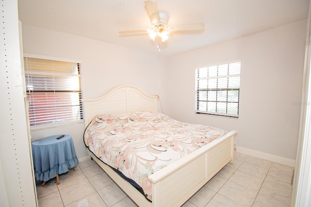 tiled bedroom with multiple windows and ceiling fan