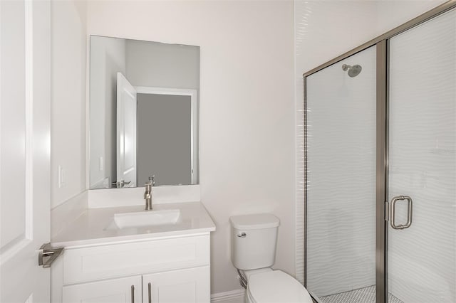 bathroom featuring a stall shower, vanity, and toilet