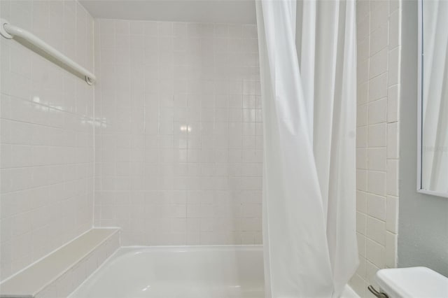 bathroom featuring toilet and shower / bathtub combination with curtain