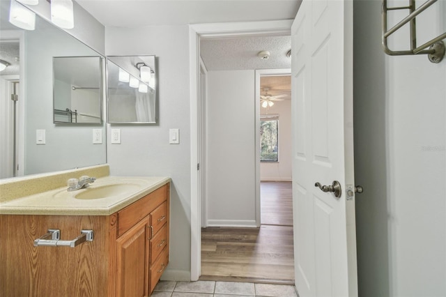 bathroom featuring tile patterned flooring, vanity, a textured ceiling, and ceiling fan