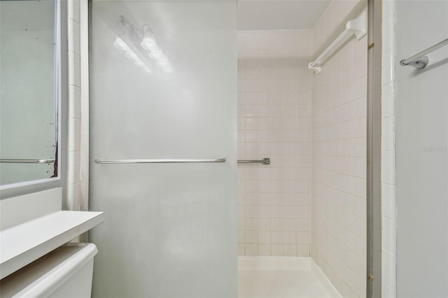 bathroom featuring toilet and tiled shower