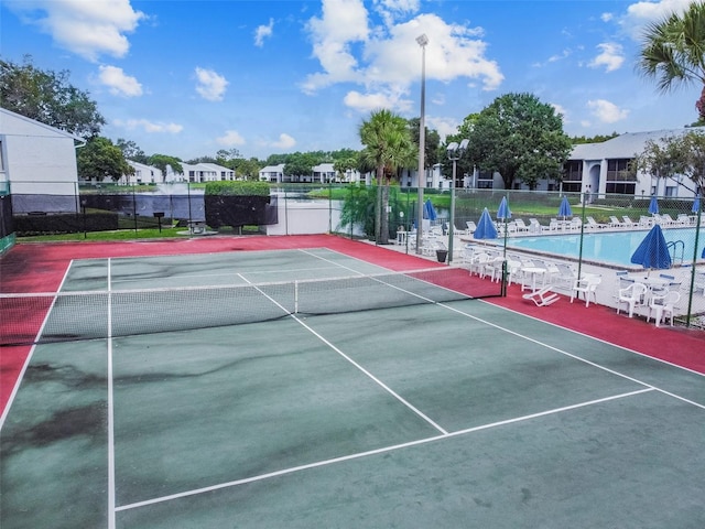 view of tennis court with a community pool and basketball court