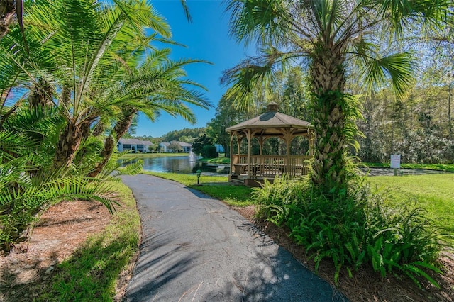 view of property's community with a gazebo and a water view