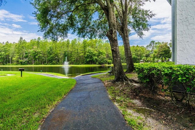 surrounding community featuring a yard and a water view