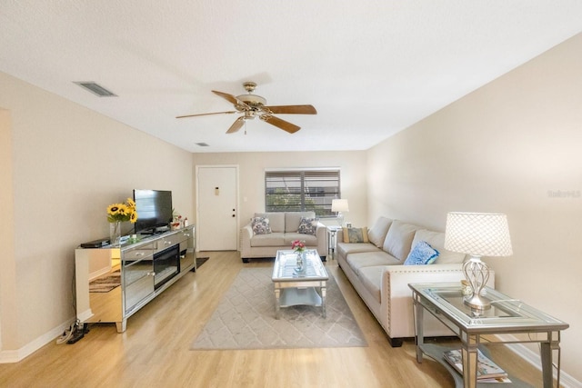 living room featuring light wood-type flooring and ceiling fan